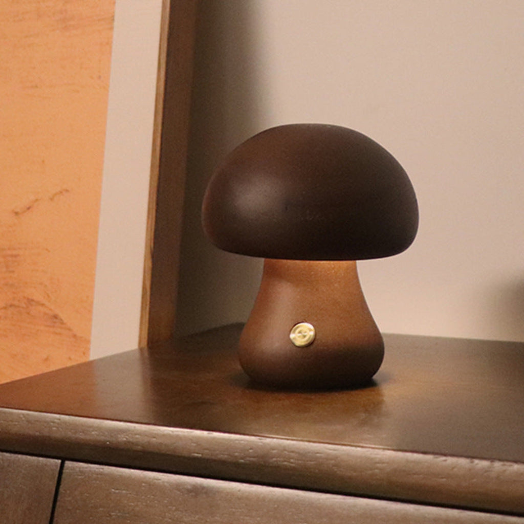 Mushroom-shaped lamp on a wooden surface with a neutral background